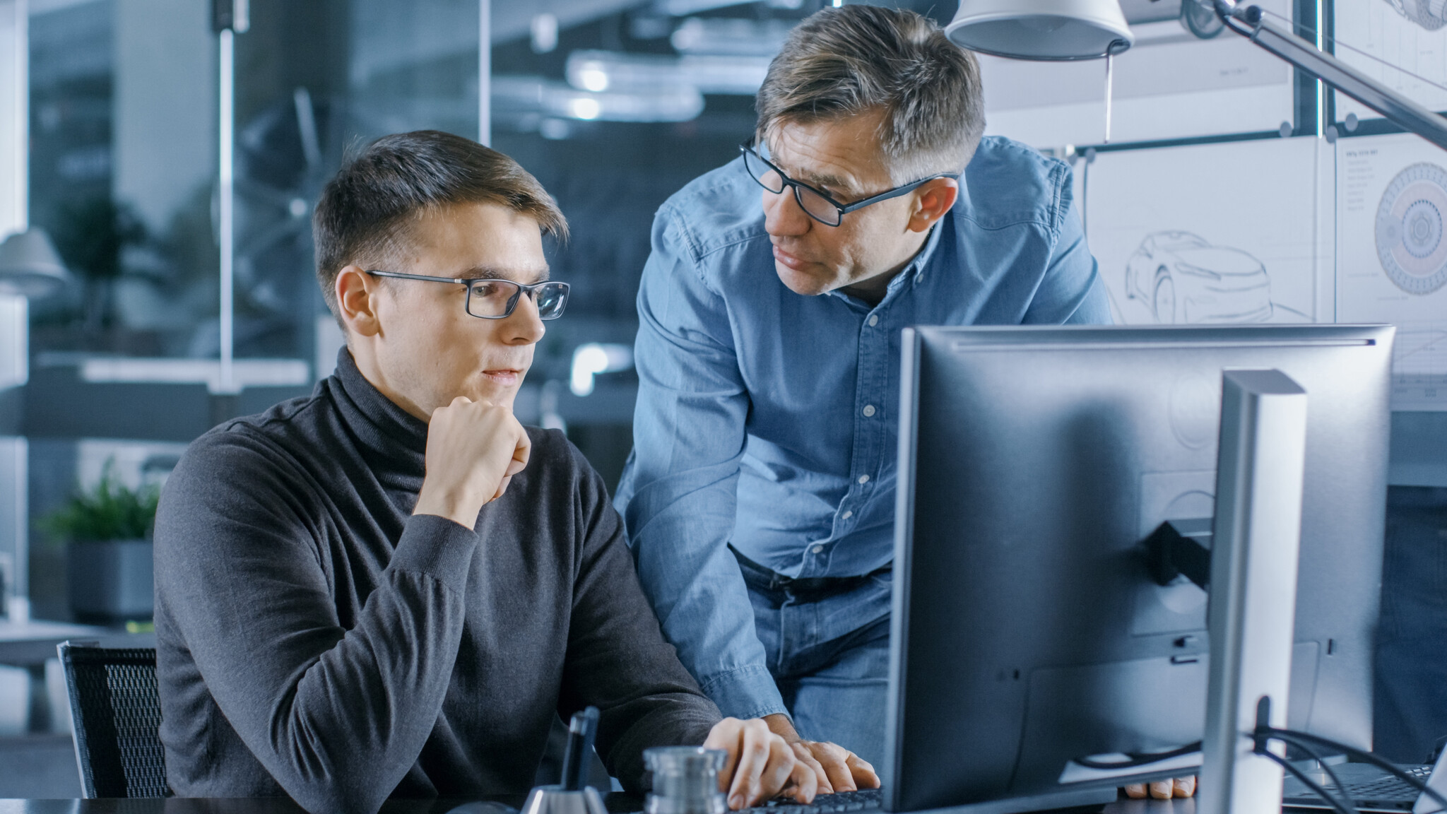 Senior Engineer Consults Young Designer