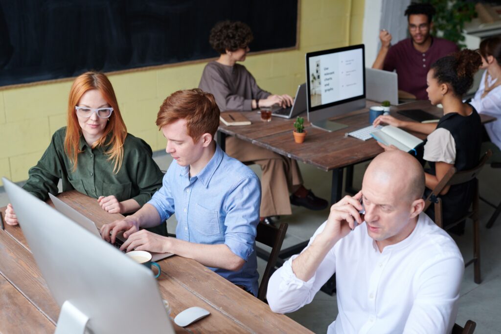 Small business team using professional IT services for small businesses to collaborate in a modern office.