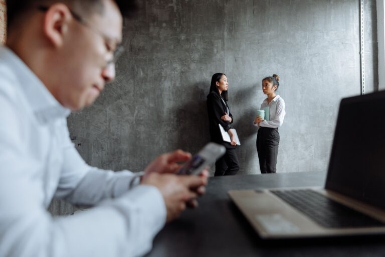 Employees working together in a modern office supported by managed cybersecurity services.