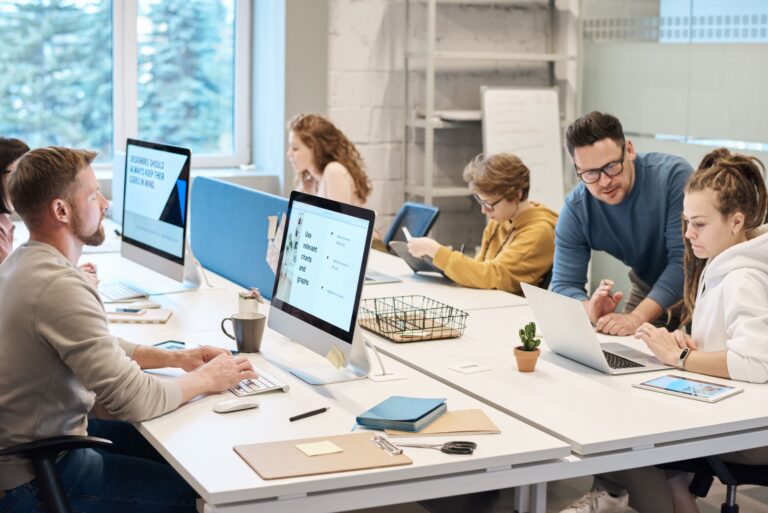 Small business employees collaborating in a modern office supported by managed IT services.