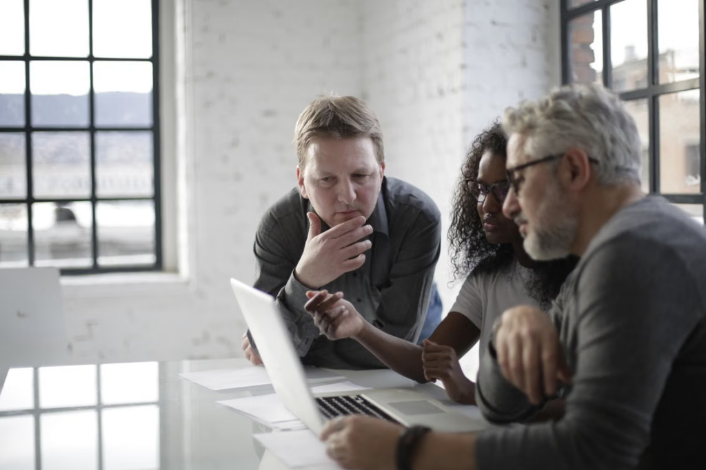 Business team discussing managed IT services vs IT outsourcing during an IT strategy meeting.