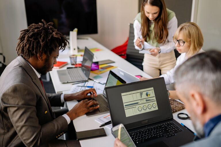 Business professionals comparing managed service providers Australia business proposals during an IT strategy meeting.