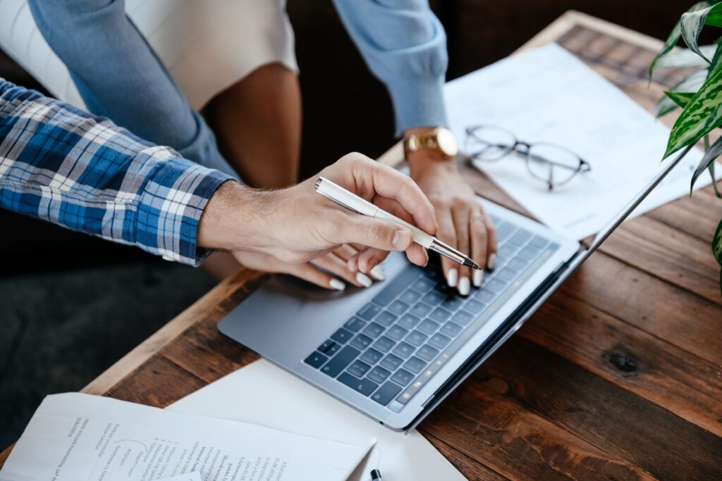 Business professionals reviewing a managed service provider Australia business proposal on a laptop during an IT consultation.
