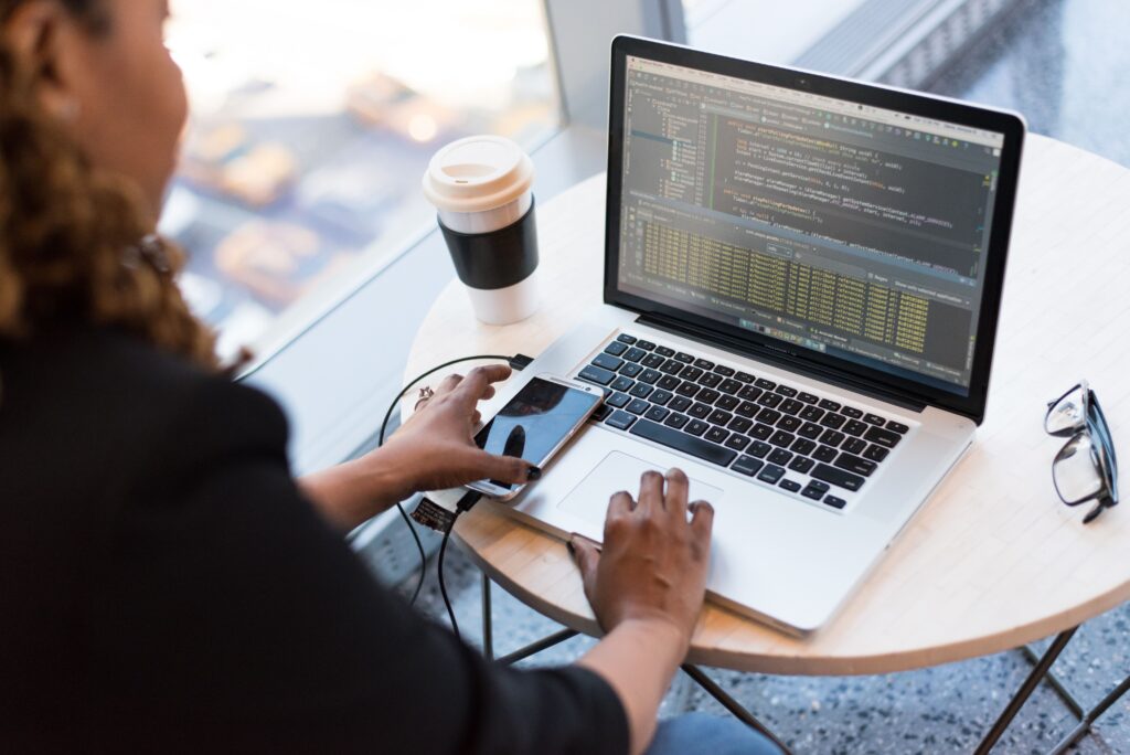 Business professional reviewing security alerts on a laptop in a modern office